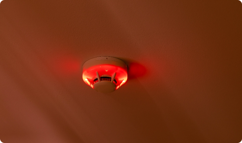 Activated smoke and fire detector on a ceiling