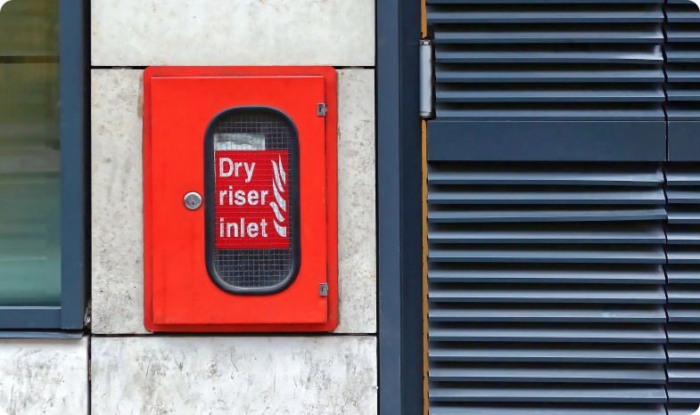 A dry riser inlet on the outside of a building